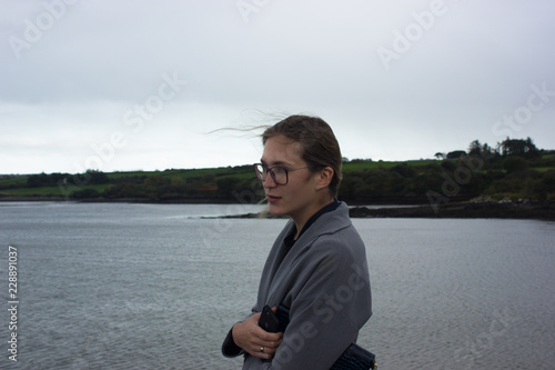 Wallpaper Mural young girl with glasses in the autumn on the background of the sea in a coat Torontodigital.ca