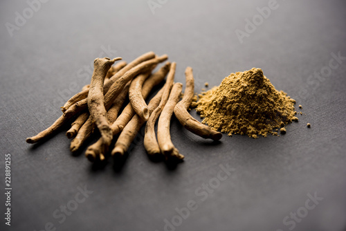 Ashwagandha / Aswaganda OR Indian Ginseng is an Ayurveda medicine in stem and powder form. Isolated on plain background. selective focus