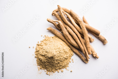 Ashwagandha / Aswaganda OR Indian Ginseng is an Ayurveda medicine in stem and powder form. Isolated on plain background. selective focus