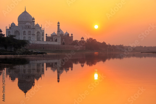 Taj Mahal reflected in Yamuna river at sunset in Agra, India © donyanedomam