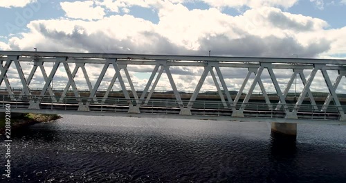 Flying on the side of the steel railroad bridge on a summer day at Kemijärvi Finland photo