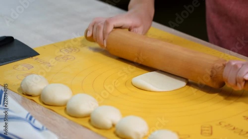 Woman roll out the dough on the table. Step by step recipe of homemade tortillas. photo