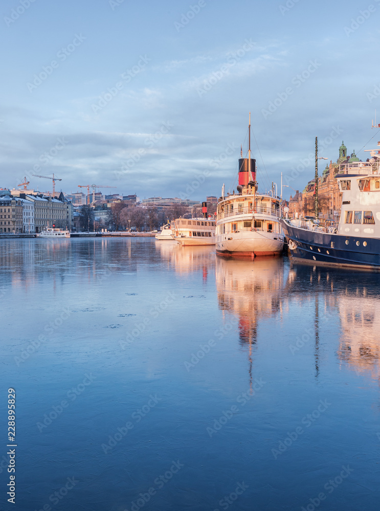 Stockholm winter image with old ship reflecting in thin ice.