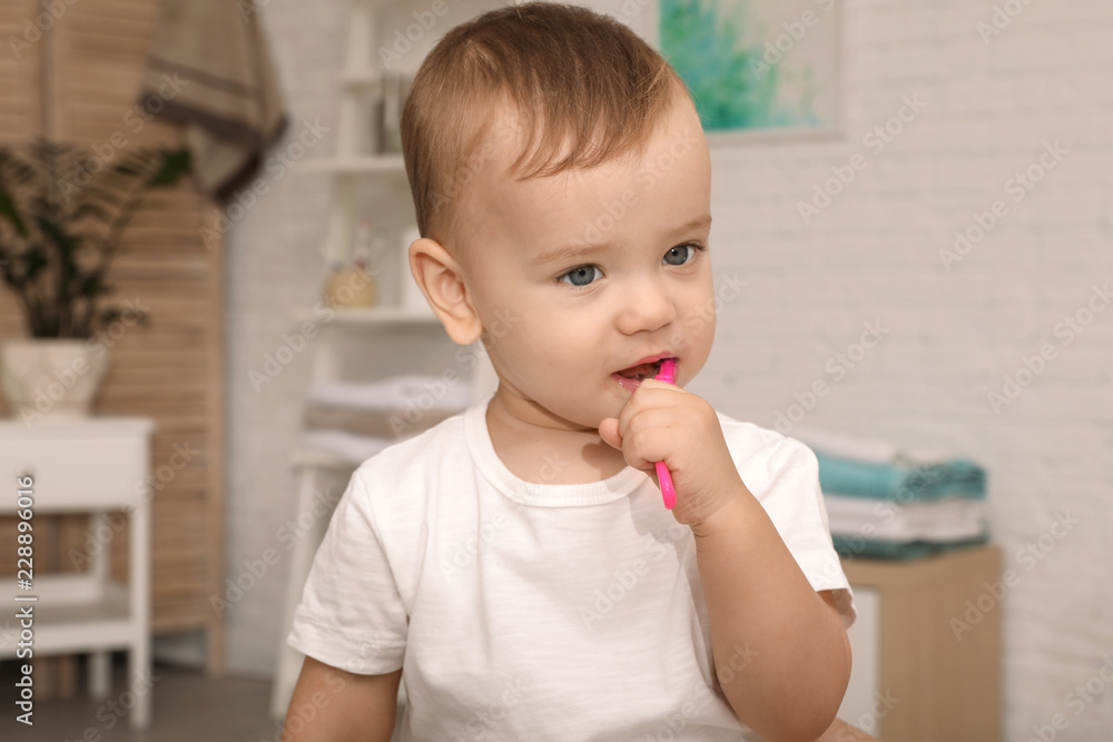 Cute little boy with toothbrush on blurred background
