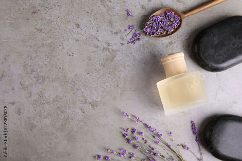 Fototapeta Naklejka Na Ścianę i Meble -  Flat lay composition with natural herbal oil and lavender flowers on color background. Space for text