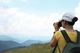 Professional nature photographer taking pictures in mountains. Space for text