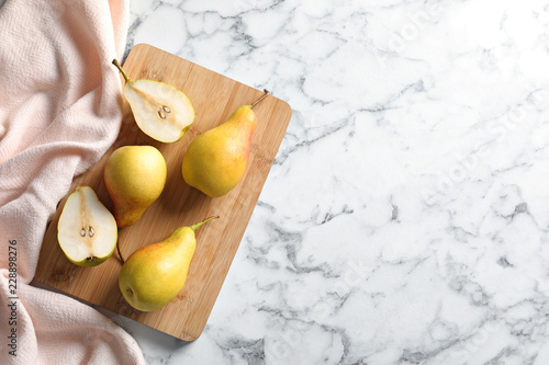 Flat lay composition with ripe pears on marble background. Space for text