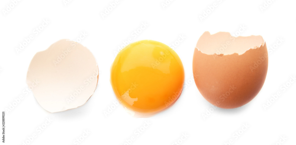 Egg yolk with cracked shell on white background, top view Egg yolk with cracked shell on white background, top view