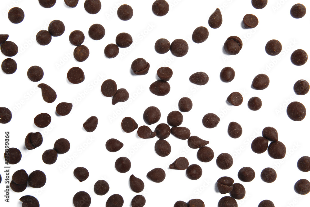 Delicious dark chocolate chips on white background, flat lay Delicious dark chocolate chips on white background, flat lay