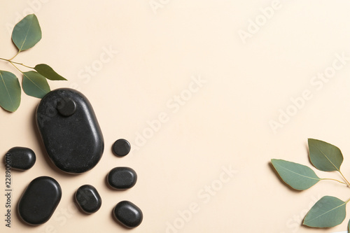 Flat lay composition with spa stones and space for text on color background
