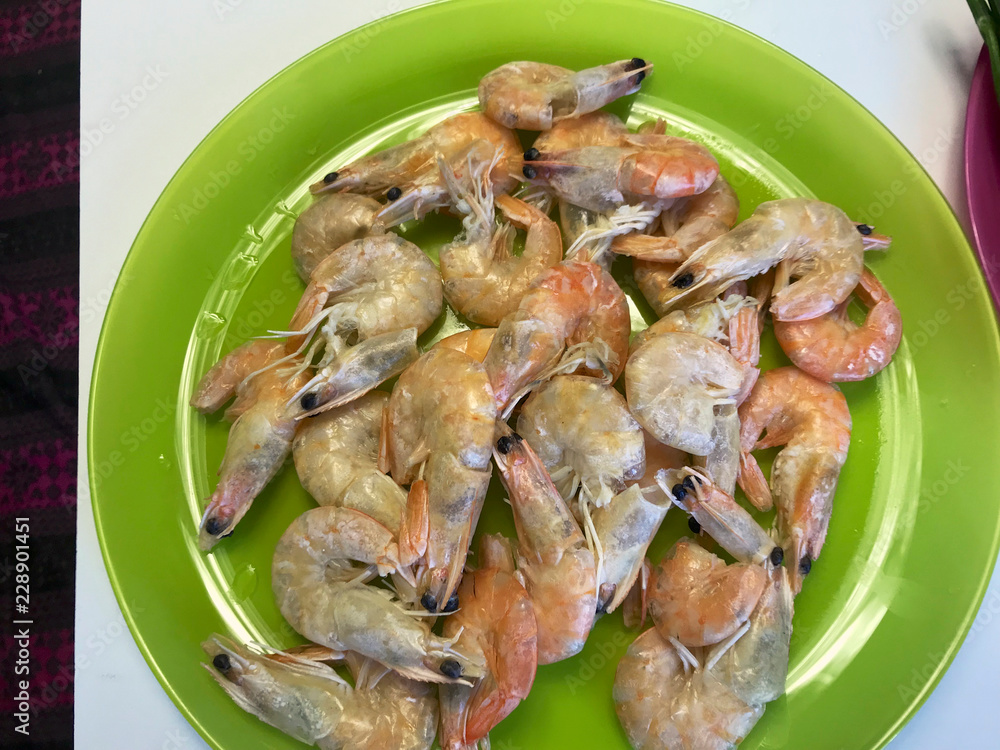 Boiled shrimps lie in a plate. Steam comes from them. Boiled shrimps lie in a plate. Steam comes from them.