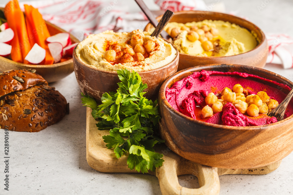 Different hummus bowls. Chickpea hummus, avocado hummus and beetroot hummus. Different hummus bowls. Chickpea hummus, avocado hummus and beetroot hummus.