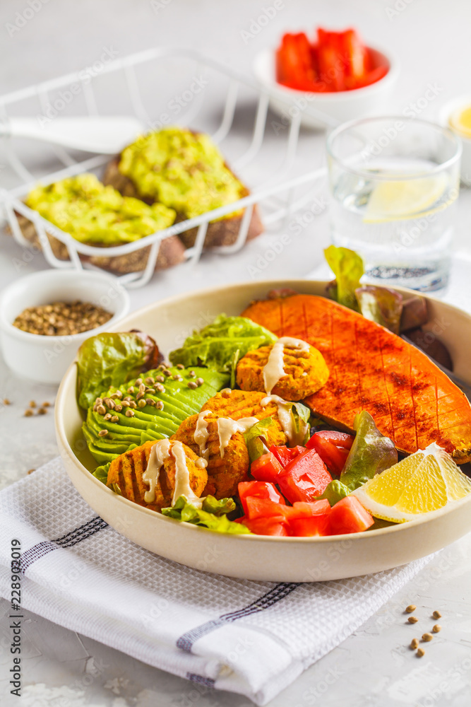 Vegan Rainbow bowl: vegetable meatballs, avocado, sweet potato and salad.