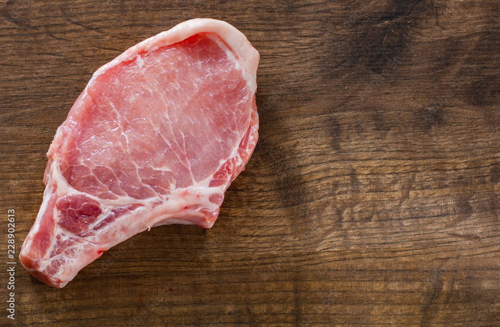 Raw Pork Loin chops meat on wooden table background with copy space. top view Raw Pork Loin chops meat on wooden table background with copy space. top view