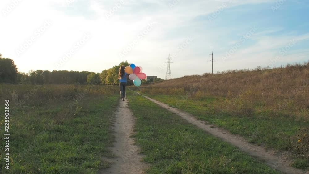 Happy childhood. Girl runs in nature with balloons. Happy childhood. Girl runs in nature with balloons.