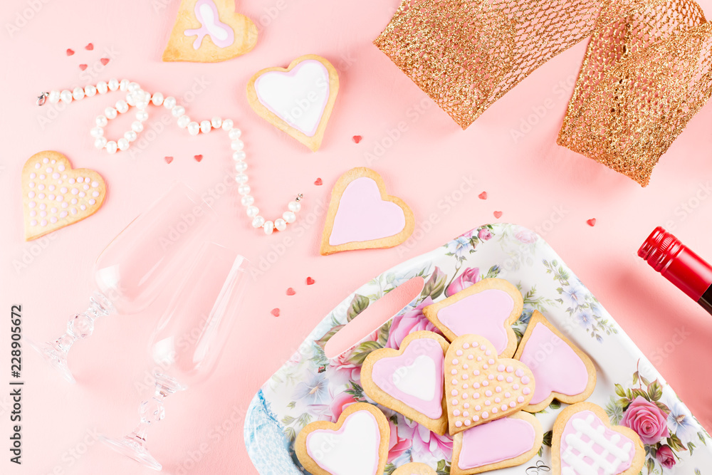 Valentine's day cookies, wine glasses and wine on pink background. Valentine's day cookies, wine glasses and wine on pink background.