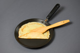 Crepe closeup, thin pancake on a frying pan, grey background