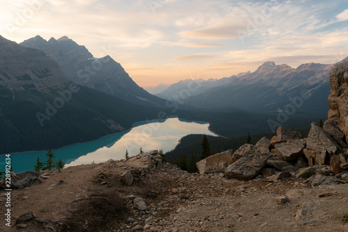The orange glow of sunset over Peyto Lake in Banff National Park on a cold winter day