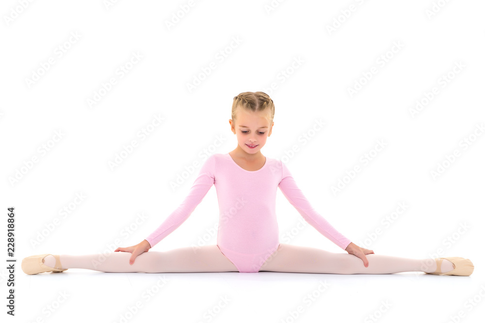 Girl gymnast perform the twine exercise. Girl gymnast perform the twine exercise.