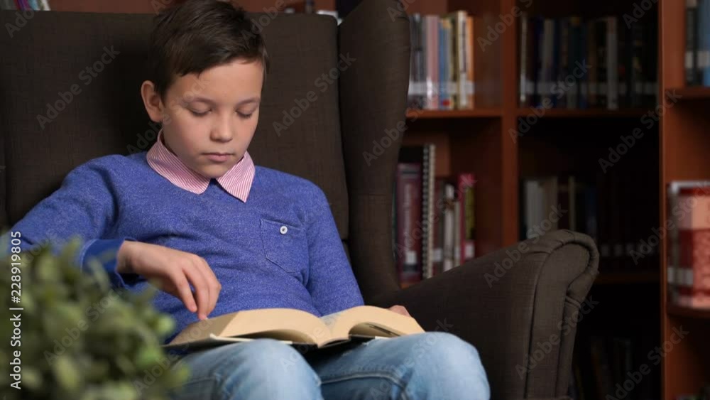 portrait of schoolboy doing their homework in library or room. portrait of schoolboy doing their homework in library or room.