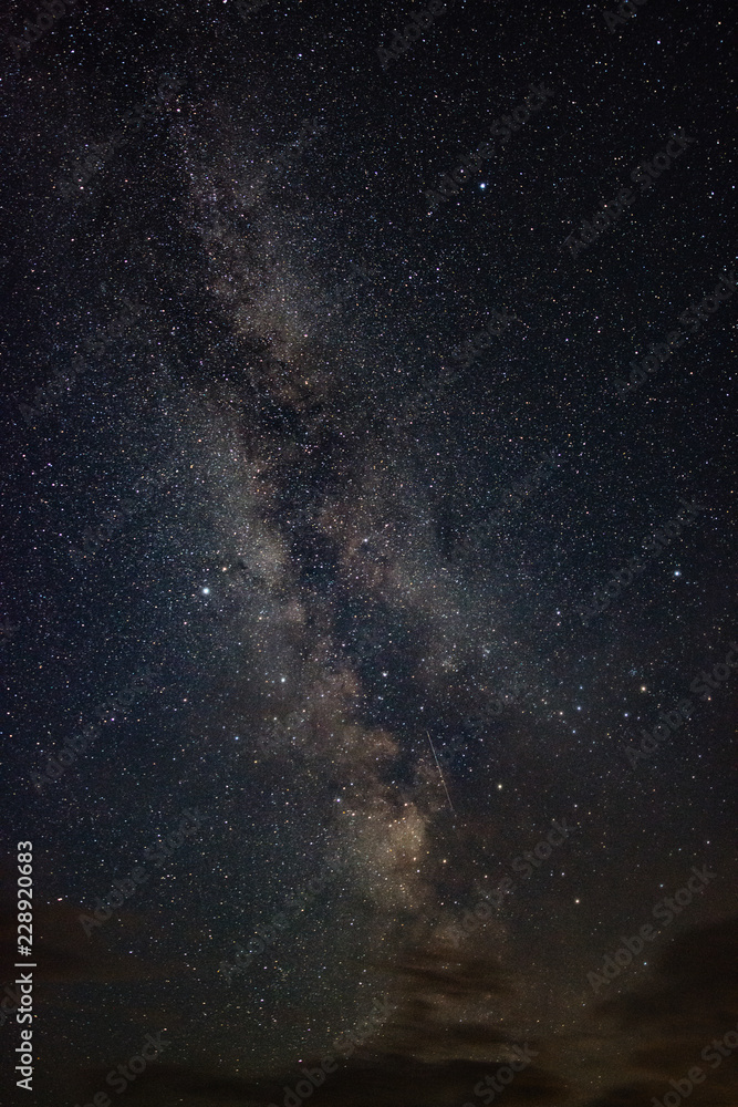 Bright milky way on a summer night through the clouds