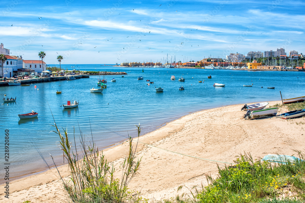 View on the Ferragudo and Portimao Algarve across the river and many fishing boats in the foreground