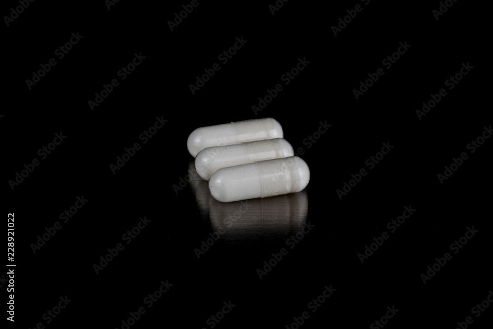 White Capsules on Black