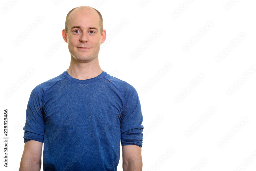 Studio shot of bald Caucasian man standing Studio shot of bald Caucasian man standing