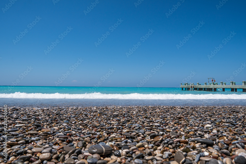 beautiful blue ocean beach and stones. landscape view.