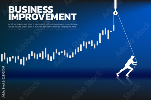 Silhouette of businessman pull up the business graph with rope and reel. concept of business improvement.