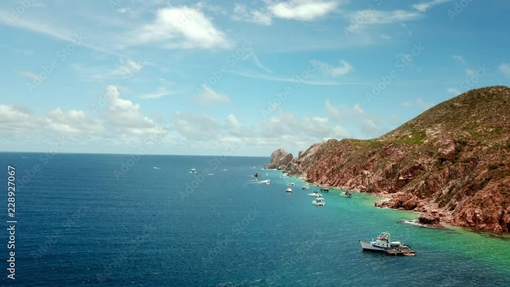 Aerial Forward: Boats Docked at Rock Cliffs in Mexico Aerial Forward: Boats Docked at Rock Cliffs in Mexico