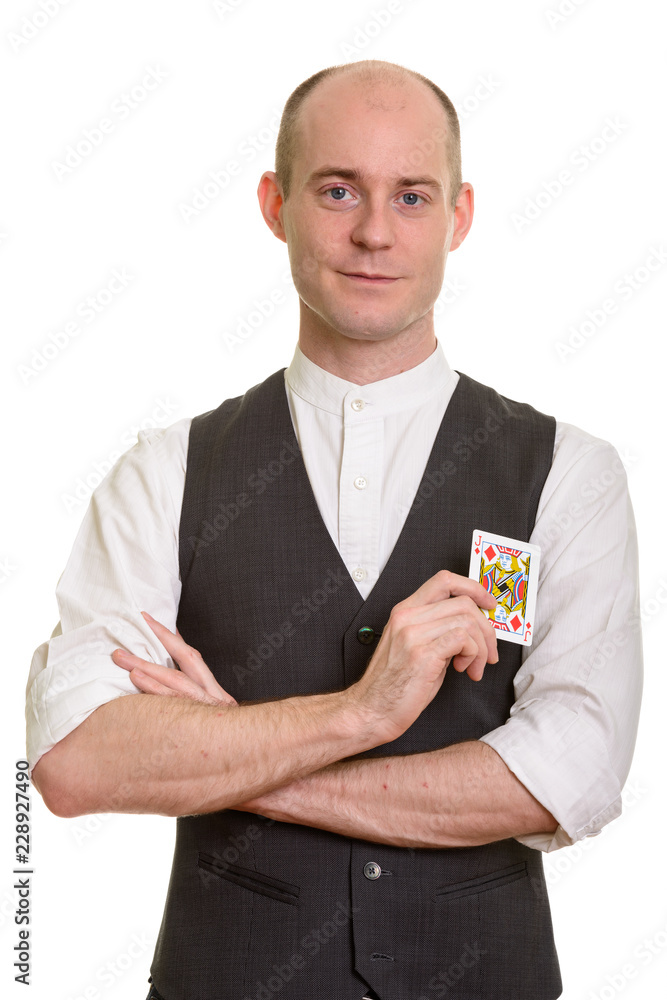 Bald Caucasian magician man holding Jack of Diamonds card with a Bald Caucasian magician man holding Jack of Diamonds card with a