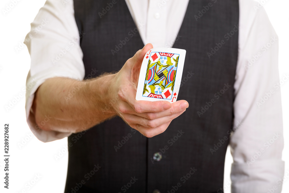 Caucasian magician man holding and bending Jack of Diamonds card Caucasian magician man holding and bending Jack of Diamonds card