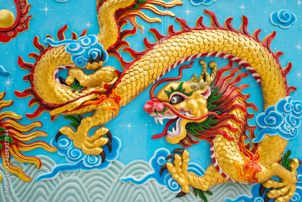 Fototapeta premium Beautiful colorful painting low relief dragon sculpture in Chinese temple wall, Kanchanaburi Thailand