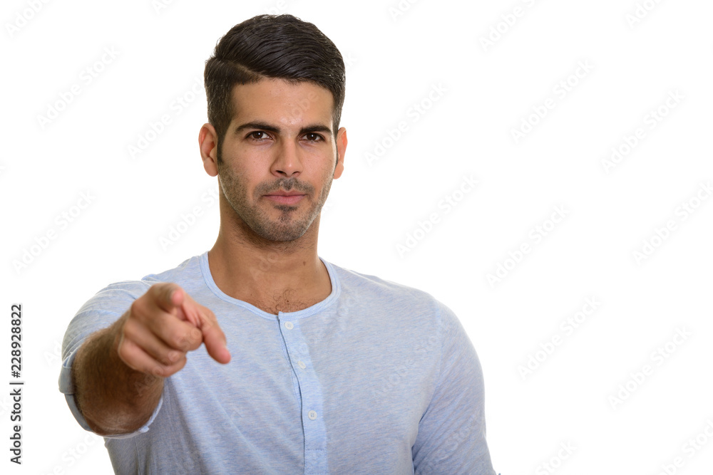Young handsome Persian man pointing at camera Young handsome Persian man pointing at camera