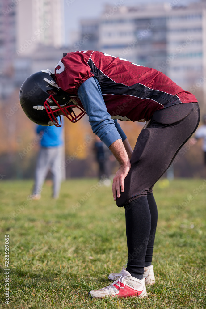 american football player resting after hard training american football player resting after hard training