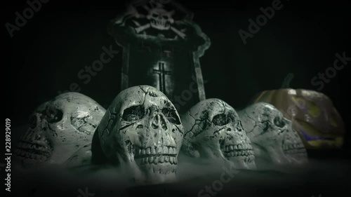 Old film look of halloween set decoration with skulls, grave and jack o'lantern