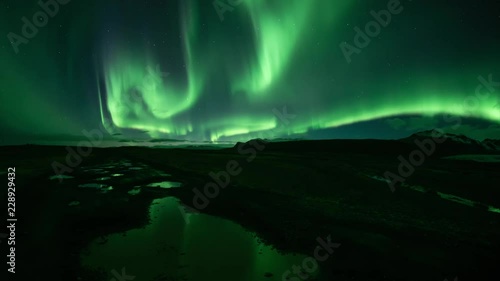 Bright realistic Aurora Borealis over mountains, reflecting in puddles, Skaftafell Iceland.mov photo