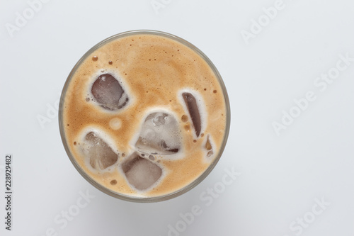 Glass of ice coffee isolated on white background from top view