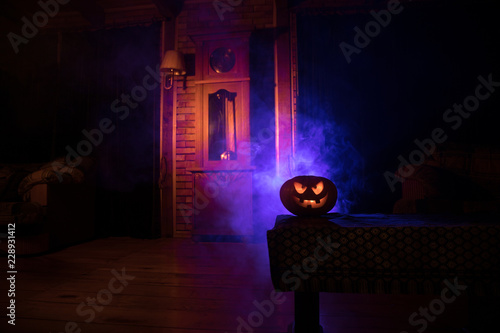 Halloween. Vintage interior in western style. Horror pumpkin with antique clock on background