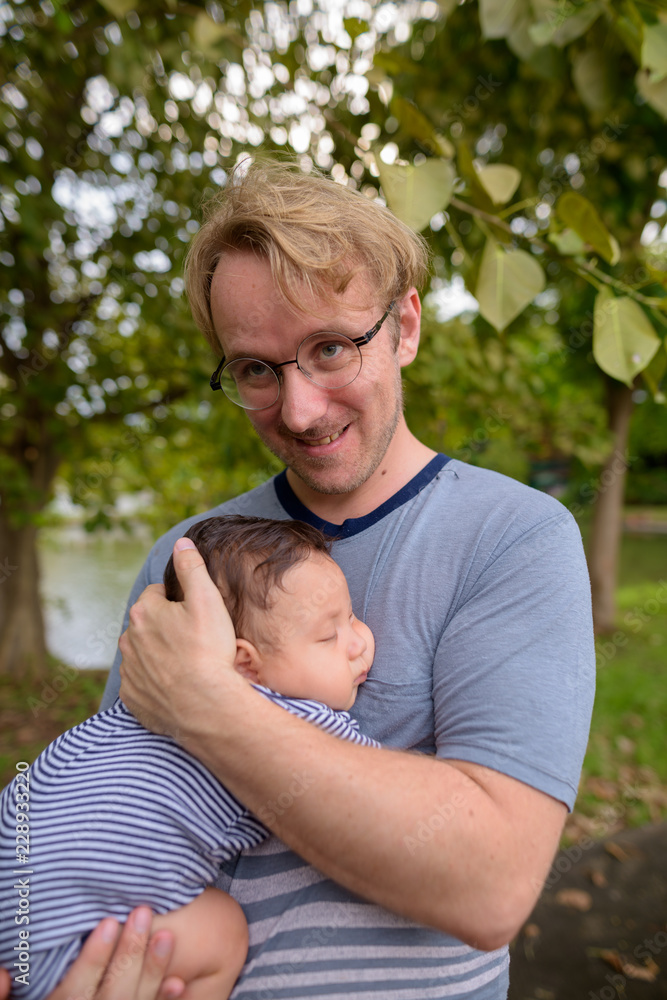 Father and baby son bonding together at the park Father and baby son bonding together at the park