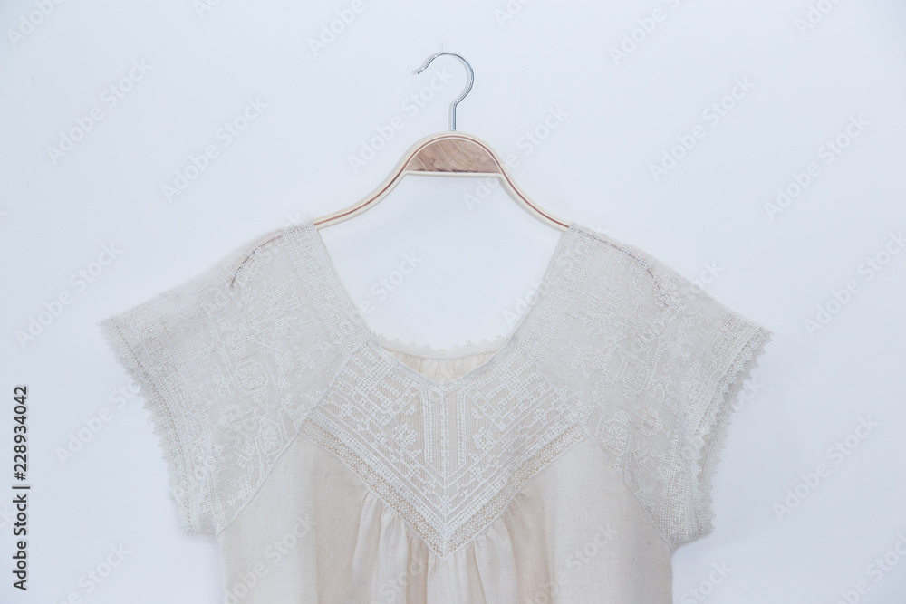 Natural colour blouse is clothes hanger on white background. Natural colour blouse is clothes hanger on white background.