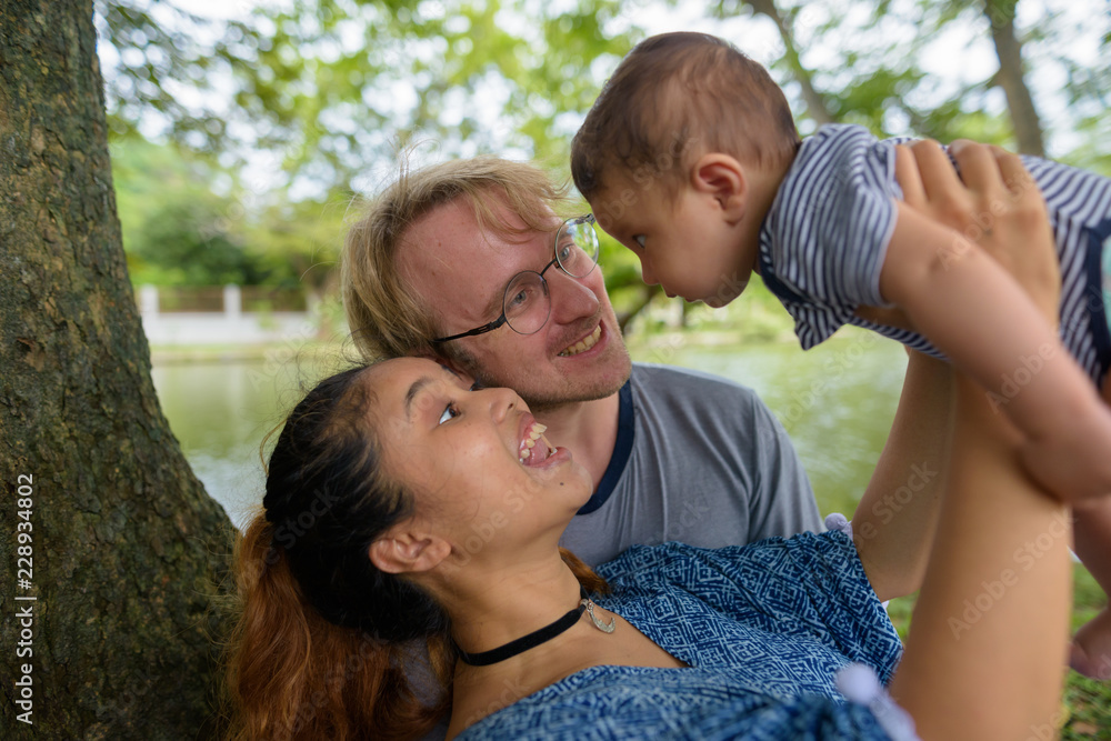 Multi-ethnic young family bonding together at the park Multi-ethnic young family bonding together at the park