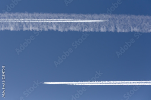 Two aircraft on a collision course. Vapor trail. © asb63