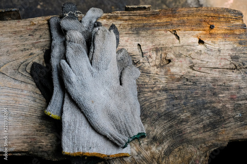 white Old and Dirty fabric gloves on old brown wood