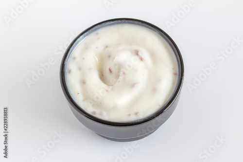 Fotografie Choc chip yogurt in a small black cup close up - Yoghurt close up