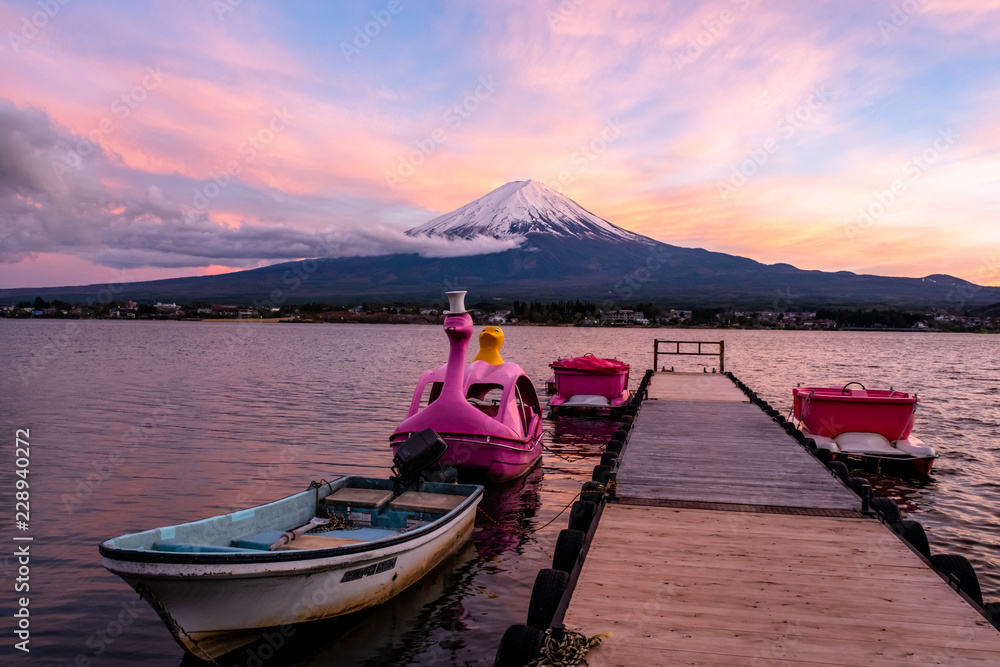 Duck boat bike at pier in Kawaguchiko lake with the amazing landscape scenery view of mount fuji in the evening sunset. Yamanashi Japan