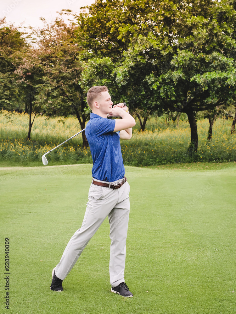 Happy golfer playing golf on green field, lifestyle concept.