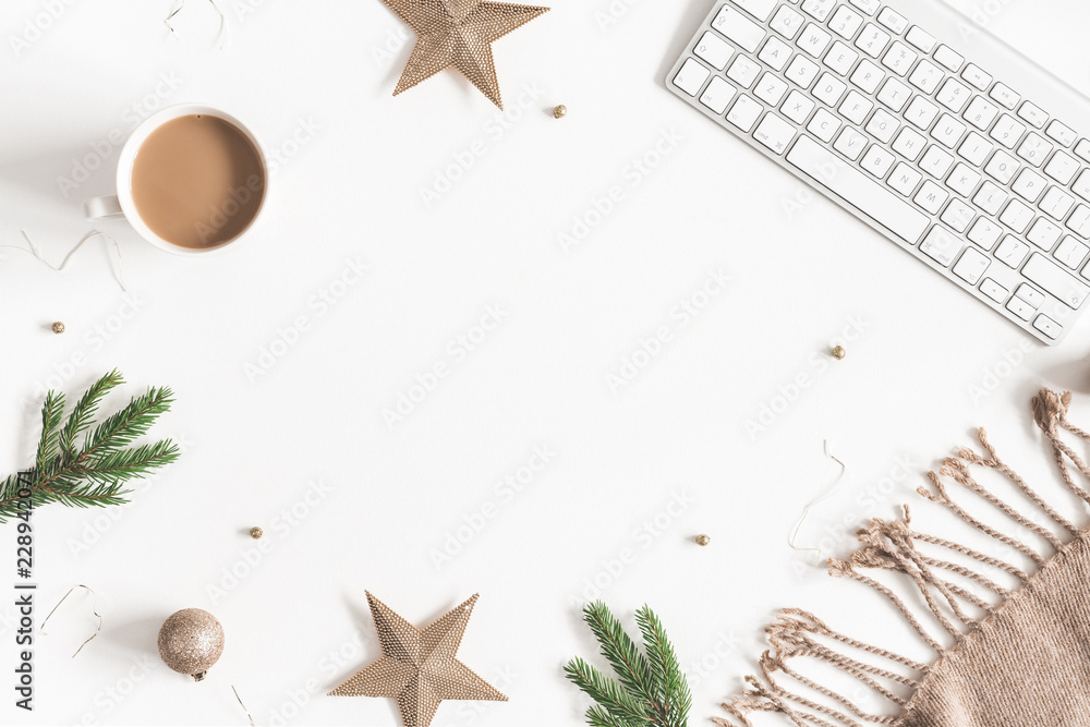 Christmas decorations, plaid, computer, fir tree branches, cup of coffee on white background. Christmas, new year, winter concept. Flat lay, top view, copy space