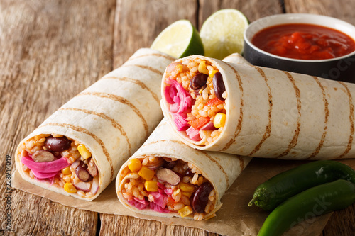 Popular appetizer vegetarian burrito with rice and vegetables close-up. horizontal